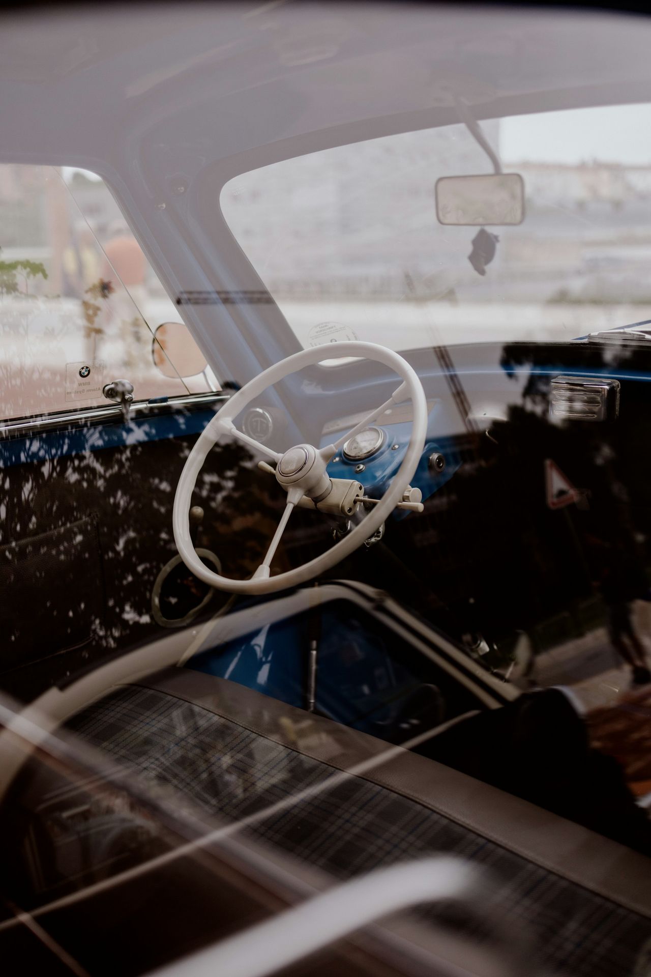 The interior of an old car with a steering wheel